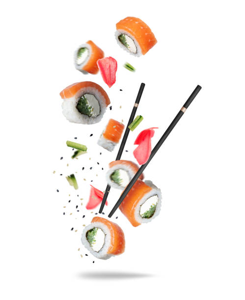 istock Floating in the air salmon rolls with black chopsticks isolated on white background 2202125962
