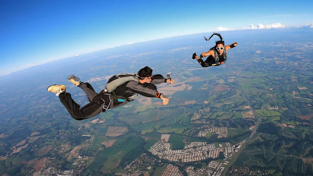 istock A heterosexual couple of skydivers kiss while free falling 2202126012