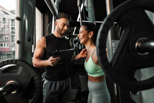 istock Young Woman With Personal Trainer 2202127271