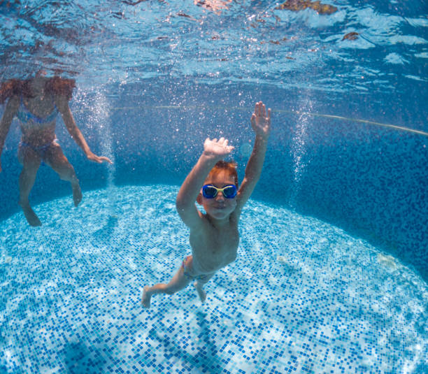 istock Cute little boy swimming underwater. 2202130223