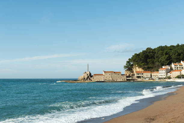 istock Mediterranean coastal town and beach with a mountain backdrop. 2202130245