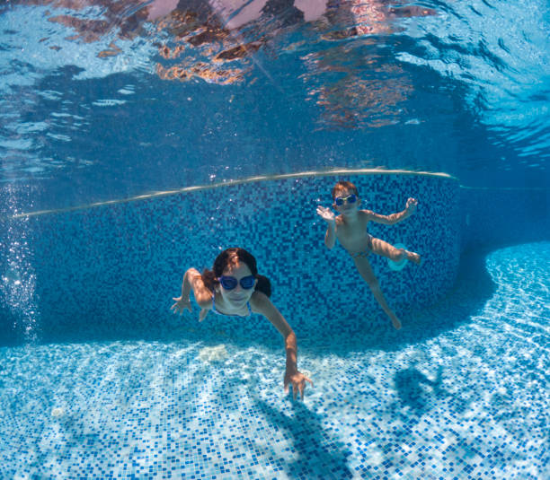 istock Kids swimming underwater. 2202132046