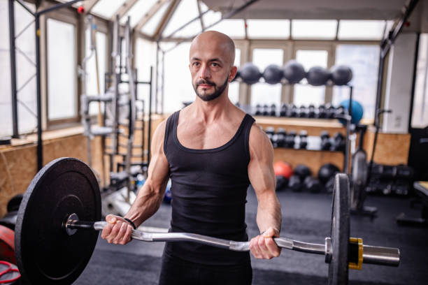 istock Weight Lifter with Determination in Modern Gym 2202133297
