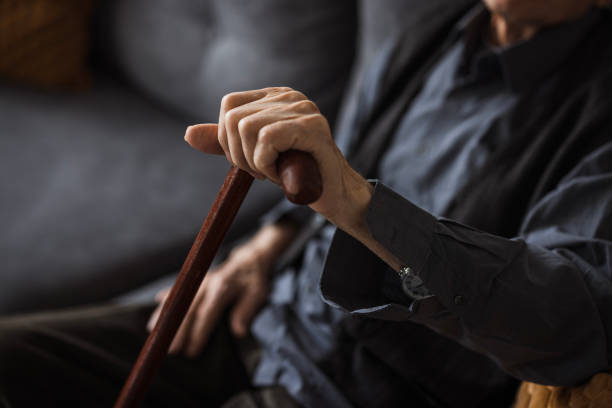 istock Elderly hand on a walking cane, close-up 2202133932