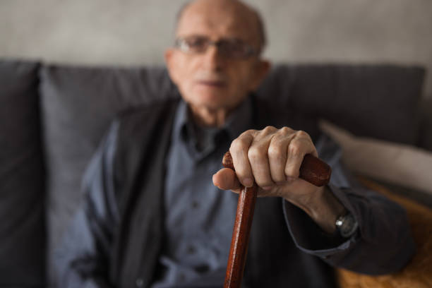 istock Elderly man with a walking cane resting 2202133935