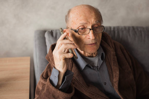 istock Elderly man resting at home and having phone conversation 2202133966