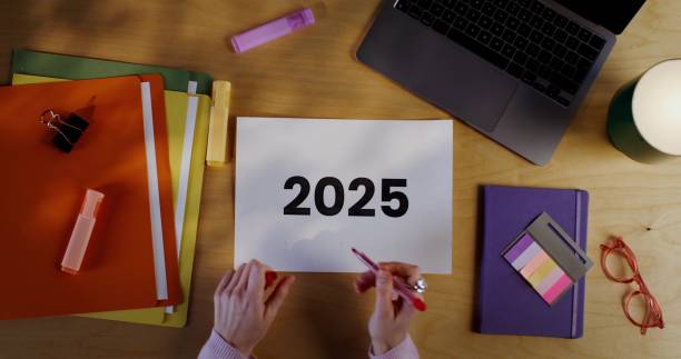 istock Woman's hands underline the inscription 2025 on the sheet 2202133991