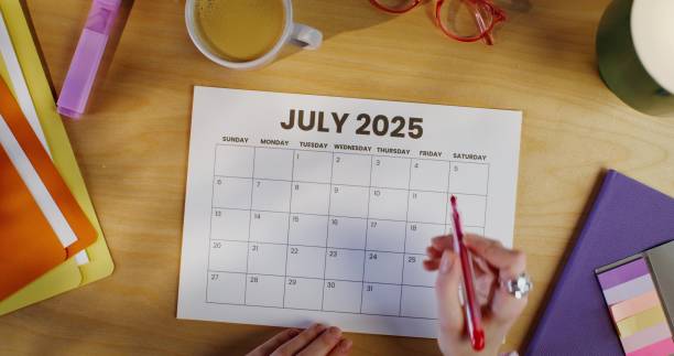 istock A woman circles a date on a calendar 2202134209