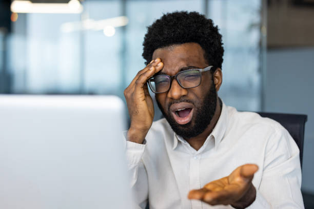 istock Frustrated and upset man looking at laptop screen, businessman at workplace inside office, looking worried while reading bad electronic financial reports 2202134350