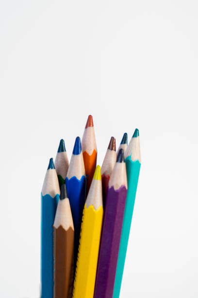 A playful photo of colorful pencils arranged in a creative messy style on a white background. Perfect for artistic and educational projects.