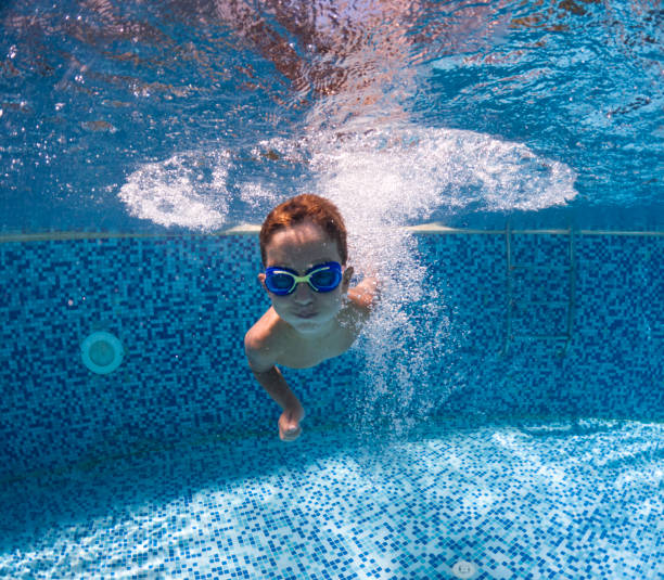 istock Cute little boy swimming underwater. 2202137092