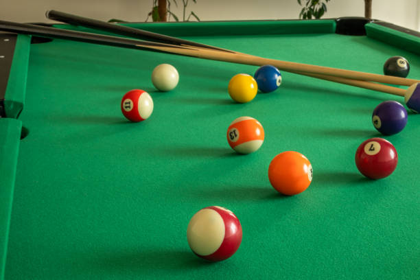istock Scattered billiard balls on a green pool table 2202137287
