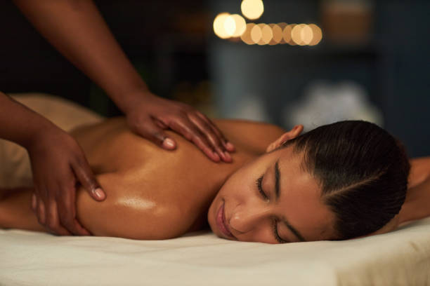 Receiving Relaxing Massage with Candles in Background