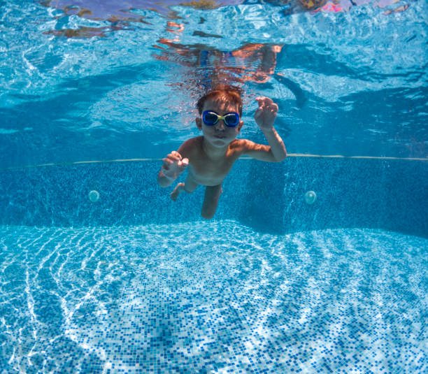 istock Cute little boy swimming underwater. 2202137825