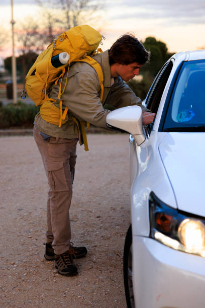 istock Backpacker talking to a driver in Madrid, Spain 2202138085