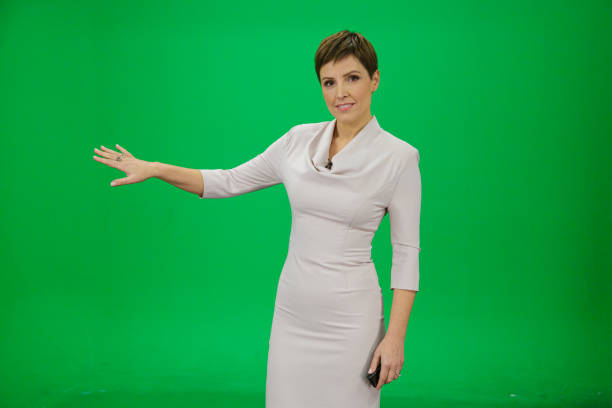 istock Confident Female Meteorologist Presenting Weather Forecast On Green Screen 2202138276