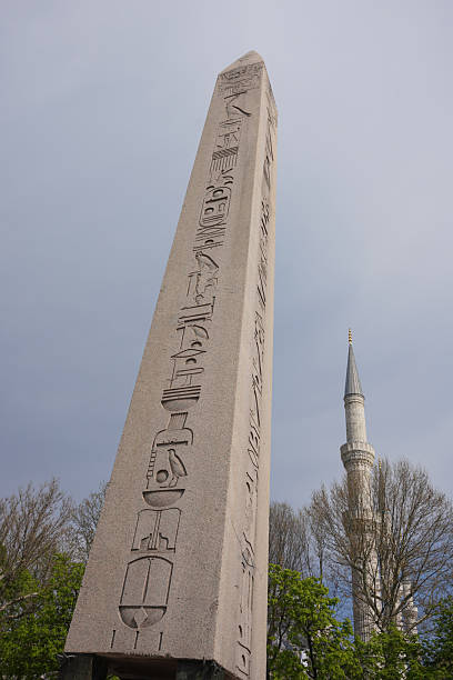 Architectural detail of a mosque in istanbul, turkey, showcasing intricate stonework, arches, and columns bathed in sunlight