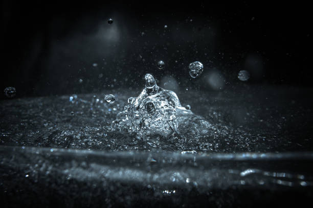istock Liquid drop on the water surface. Splash. Chemistry. 2202139860