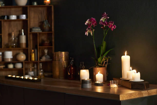 istock Illuminated Candles With Wooden Shelf and Vases 2202140918