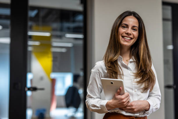 istock Smiling businesswoman holding digital tablet in modern office 2202141346