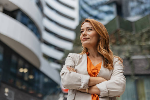 istock Thoughtful woman with arms crossed confidently. 2202141390