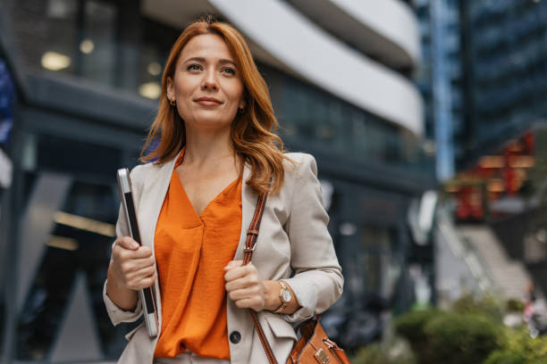 istock Businesswoman attentively using phone in city setting 2202141659