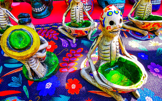 Man with typical Mexican-style Day of the Dead (Dia de los Muertos), sugar skull make-up, dressed in white suit and hat. Dark, Surreal Portrait.