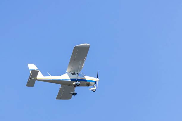 istock A small propeller airplane soaring through the clear blue sky, showcasing its sleek design against the backdrop of a calm and serene sky 2202142775