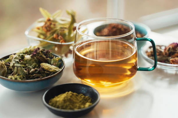 istock Warm Tea Surrounded by Natural Dried Herbs 2202147527