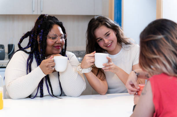 istock Young women enjoying a coffee break together in a modern kitchen 2202147827