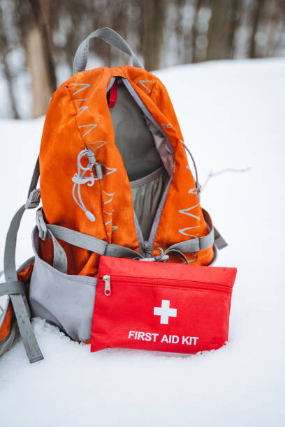 istock A sturdy backpack equipped with a comprehensive first aid kit lies on the snowcovered ground, creating a striking contrast against the brilliant white backdrop of the vast winter landscape 2202147978