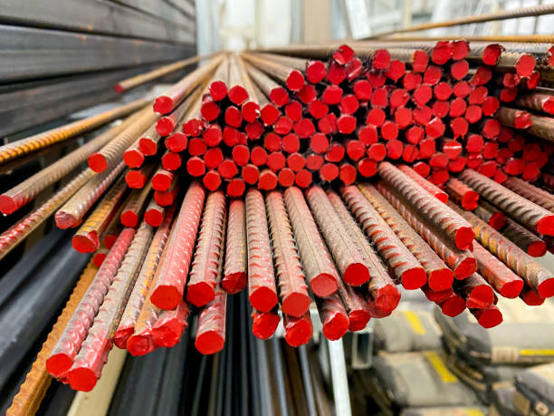 A meticulously organized and arranged stack of vibrant red metal bars forms a visually striking and appealing structure that highlights the beauty of these materials and their arrangement