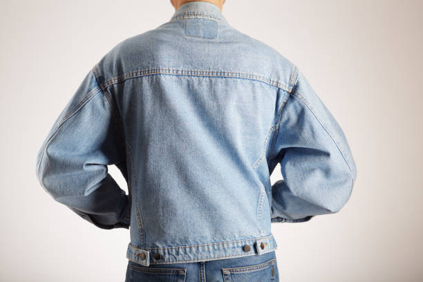 istock Rear view of a man in old fashioned double denim jacket and jeans 2202148394