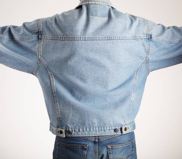 istock Rear view of a man in old fashioned double denim jacket and jeans 2202148452