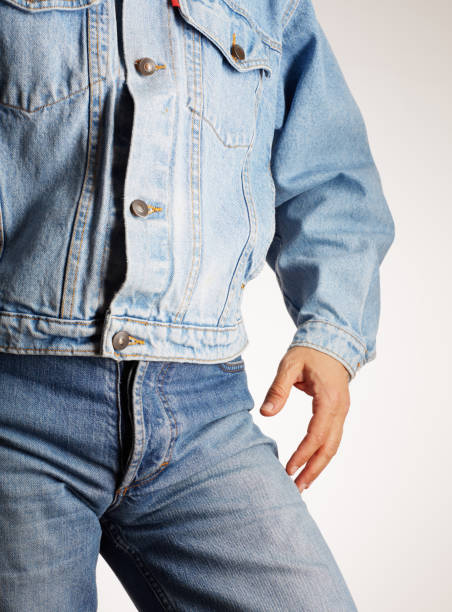 istock Rear view of a man in old fashioned double denim jacket and jeans 2202148453