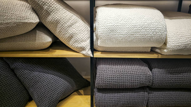 istock Bed linens, pillows, textiles and towels on a shelf 2202149568