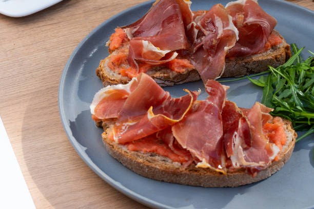 jamon bruschetta prosciutto appetizer portioned tapas dish natural tasty snack fresh delicious gourmet food background on the table rustic top view copy space
