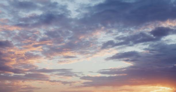 istock The sky covered with thick clouds illuminated by bright light of the rising sun 2202150059