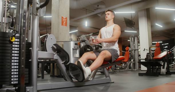 istock A young man is engaged in an exercise machine, shaking his chest muscles 2202155081