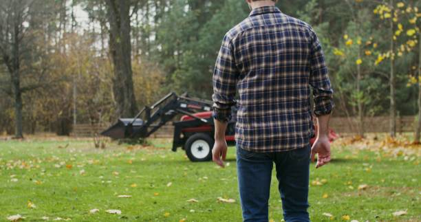 istock A young man gets into a tractor, getting ready to work in field on autumn day 2202155380