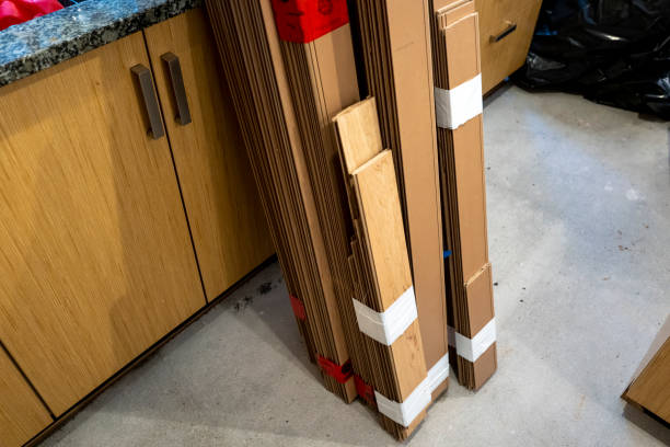 Replacement wooden flooring stacked in a basement kitchen flor flood damage and repairs