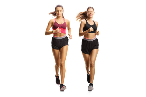istock Two young women jogging together side by side 2202156154