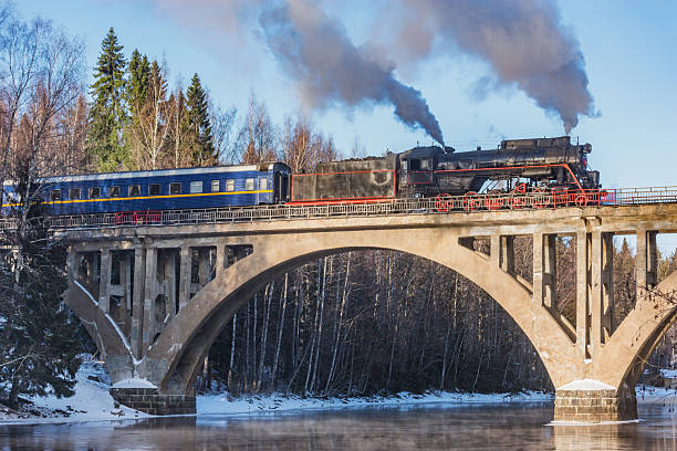 istock Retro train moves above the river. 2202159029