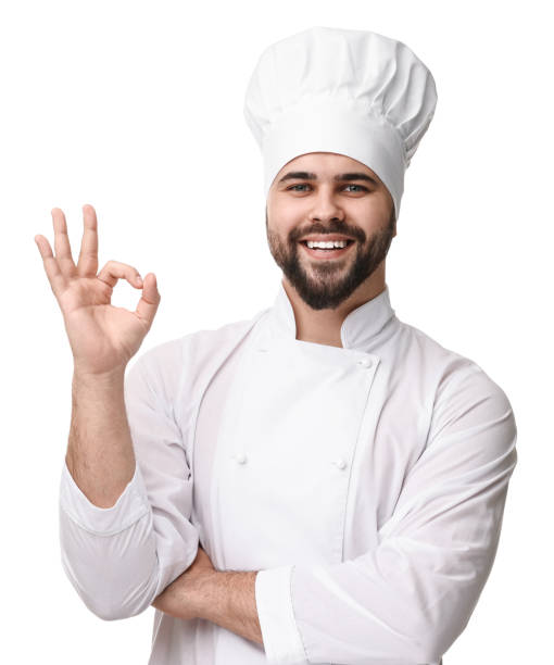 istock Happy young chef in uniform showing ok gesture on white background 2202160691