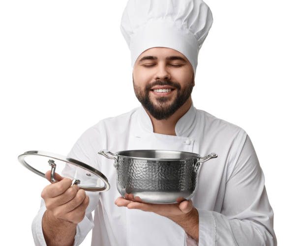istock Happy young chef in uniform holding cooking pot on white background 2202160782