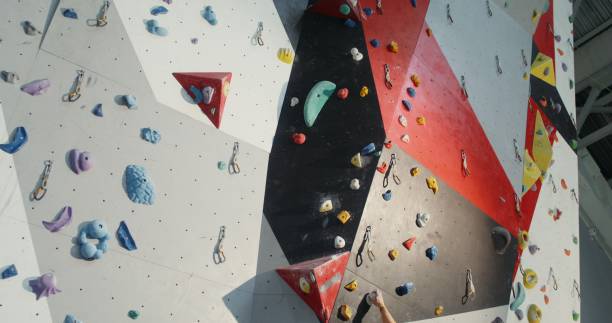 istock A young man climbs up the indoor climbing wall without safety ropes 2202161172