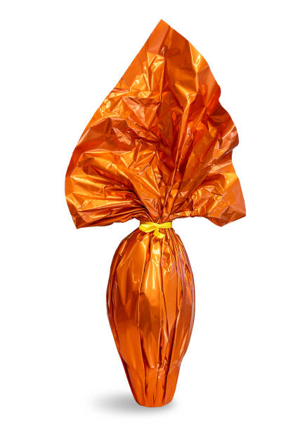 istock Easter chocolate egg wrapped in sparkling paper orange colored 2202161308