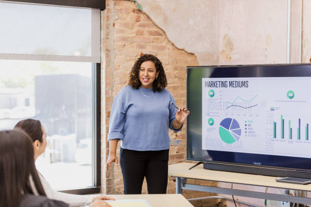 istock Businesswoman giving presentation, using laptop and charts 2202161400