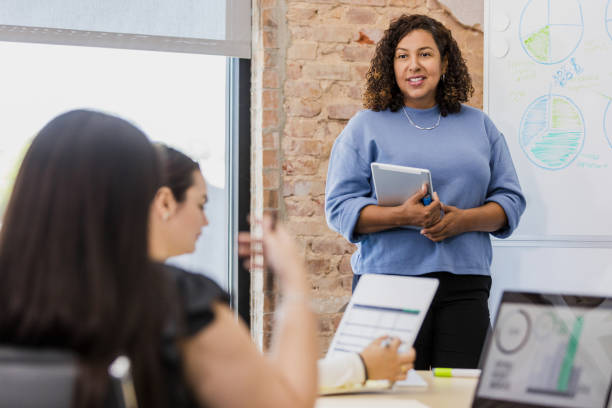 istock Businesswoman giving presentation using tablet during meeting 2202161419