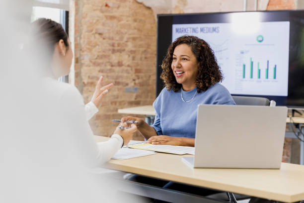 istock Two Businesswomen Having a Discussion in Modern Office 2202161428